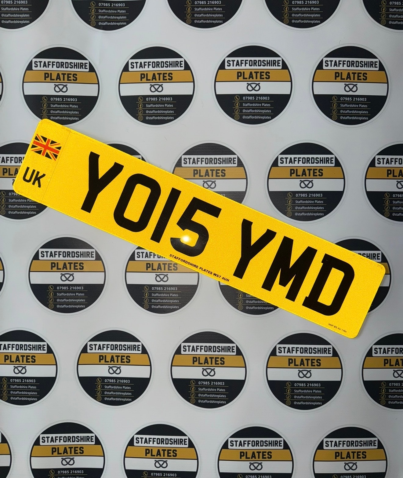 Yellow YO15 YMD custom number plate with UK badge